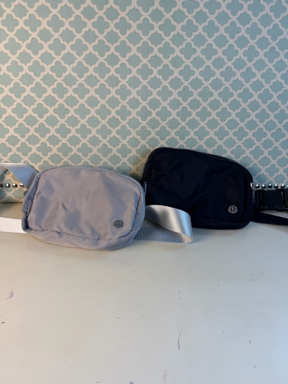 Two small Lululemon belt bags gray and black